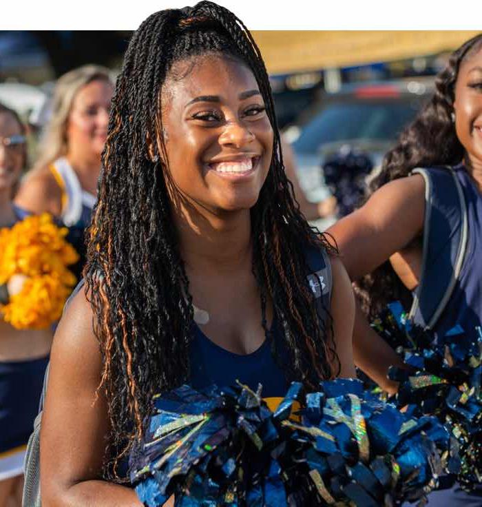 TAMUC Cheerleader smiling at the camera.